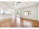 Bright living room with wood floors, and large windows overlooking the backyard and kitchen area at 9539 Iris Flat Ct, Las Vegas, NV 89178