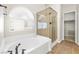 Relaxing main bathroom with a soaking tub and separate glass shower enclosure at 9539 Iris Flat Ct, Las Vegas, NV 89178