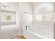 Bright main bathroom featuring a large tub and a glimpse of the main bedroom at 9539 Iris Flat Ct, Las Vegas, NV 89178