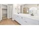Well-lit main bathroom with double sinks, tile floors, and a glass shower at 9539 Iris Flat Ct, Las Vegas, NV 89178