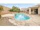 Backyard pool with lush landscaping and stone accents, creating a serene and inviting outdoor space for relaxation at 9539 Iris Flat Ct, Las Vegas, NV 89178