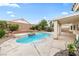 Backyard pool with lush landscaping, rock features, and a surrounding patio, perfect for outdoor relaxation and entertainment at 9539 Iris Flat Ct, Las Vegas, NV 89178