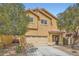 Two-story home featuring a two-car garage and desert landscaping at 9651 Bouncing Ball St, Las Vegas, NV 89178