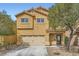 Two-story home with an attached two-car garage and a well-manicured front yard at 9651 Bouncing Ball St, Las Vegas, NV 89178