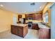 Kitchen featuring stainless steel appliances, dark wood cabinets, and granite countertops at 9651 Bouncing Ball St, Las Vegas, NV 89178