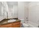 Bathroom with granite countertop, wooden cabinets, sink, toilet and tub at 2285 Villefort Ct, Las Vegas, NV 89117