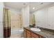 Bathroom featuring granite countertop, shower and tub combination, and well-lit mirror at 2285 Villefort Ct, Las Vegas, NV 89117