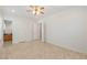 Bright bedroom featuring a ceiling fan, multiple doors, and neutral tile floors at 2285 Villefort Ct, Las Vegas, NV 89117