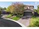 Charming two-story home with a three-car garage and lush green landscaping at 2285 Villefort Ct, Las Vegas, NV 89117