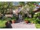 Inviting front entrance featuring a brick pathway, lush greenery, and stone accents at 2285 Villefort Ct, Las Vegas, NV 89117