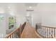 An upstairs hallway features wrought iron railings and abundant natural light at 2285 Villefort Ct, Las Vegas, NV 89117