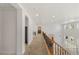 Upstairs hallway featuring carpet flooring, recessed lighting, and wood and iron banister at 2285 Villefort Ct, Las Vegas, NV 89117