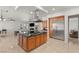 Open kitchen boasts stainless steel appliances, an island with cooktop, and seamless access to the living area, perfect for hosting at 2285 Villefort Ct, Las Vegas, NV 89117