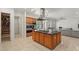 Modern kitchen featuring a center island with stainless steel appliances, ample cabinetry, and convenient pantry access at 2285 Villefort Ct, Las Vegas, NV 89117