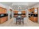 Well-equipped kitchen with stainless steel appliances, black countertops, island, and tile flooring, perfect for cooking at 2285 Villefort Ct, Las Vegas, NV 89117