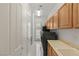 Laundry room with black washer and dryer, tile floors, wooden cabinets and utility sink at 2285 Villefort Ct, Las Vegas, NV 89117
