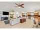 Expansive living area with fireplace, open kitchen, comfortable seating, and tile floors, designed for modern living at 2285 Villefort Ct, Las Vegas, NV 89117