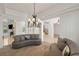Spacious living room with natural lighting, fireplace, and stairs with dark iron at 2285 Villefort Ct, Las Vegas, NV 89117