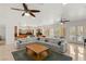 Open concept living area, seamlessly connecting the kitchen and living space with a comfortable gray sofa at 2285 Villefort Ct, Las Vegas, NV 89117