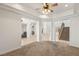 Open-concept living room with pillars, tile floors, and a view of the staircase and fireplace at 2285 Villefort Ct, Las Vegas, NV 89117