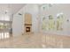 Bright living room features a fireplace, tall windows, and tiled floors, providing an open and airy atmosphere at 2285 Villefort Ct, Las Vegas, NV 89117