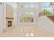 Bright living room with tall windows, fireplace, and tile flooring, creating a luxurious ambiance at 2285 Villefort Ct, Las Vegas, NV 89117
