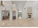 Bright living room with tile floors, a fireplace, and views of the kitchen and foyer at 2285 Villefort Ct, Las Vegas, NV 89117