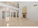 Expansive living room featuring a fireplace, tile flooring, and a staircase leading to the second floor at 2285 Villefort Ct, Las Vegas, NV 89117