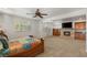 A luxurious main bedroom with a fireplace, tv, natural light, and neutral carpet at 2285 Villefort Ct, Las Vegas, NV 89117