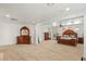 This spacious main bedroom features beautiful wood furniture, natural light, and neutral carpet at 2285 Villefort Ct, Las Vegas, NV 89117