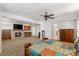 A beautiful main bedroom features a fireplace, a tv, and a ceiling fan at 2285 Villefort Ct, Las Vegas, NV 89117