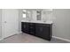 Modern bathroom featuring double vanity with black cabinets and a walk-in shower at 2293 Teatro Ave, Henderson, NV 89044