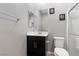 Bathroom features a modern vanity with black cabinets and a neutral color palette at 2293 Teatro Ave, Henderson, NV 89044