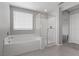Bathroom featuring tub, separate shower and bright window at 2293 Teatro Ave, Henderson, NV 89044