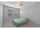 Bright, carpeted bedroom with a ceiling fan and natural light from two windows at 2293 Teatro Ave, Henderson, NV 89044