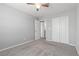 Bright bedroom features carpet, ceiling fan and closet, with neutral walls at 2293 Teatro Ave, Henderson, NV 89044
