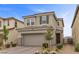 Charming two-story home featuring a two-car garage, a brown-tiled roof, and drought-resistant landscaping at 2293 Teatro Ave, Henderson, NV 89044