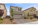 Two-story home featuring desert landscaping with a well-manicured front yard and attached two-car garage at 2293 Teatro Ave, Henderson, NV 89044