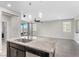 Kitchen featuring granite countertops, an island with a sink, and an open view into the living room at 2293 Teatro Ave, Henderson, NV 89044
