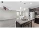 Modern kitchen features an island with granite countertops and stainless steel appliances at 2293 Teatro Ave, Henderson, NV 89044
