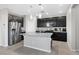 Bright kitchen with stainless steel appliances, granite counters and island with modern pendant lighting at 2293 Teatro Ave, Henderson, NV 89044