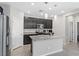 Kitchen with dark cabinetry, granite countertops, stainless steel appliances, and tile flooring at 2293 Teatro Ave, Henderson, NV 89044