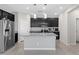 Well-lit kitchen featuring stainless steel appliances, granite countertops, and functional center island at 2293 Teatro Ave, Henderson, NV 89044