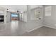 A spacious living room with tile flooring, ceiling fan, and sliding glass doors to the outside patio at 2293 Teatro Ave, Henderson, NV 89044