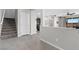 Open-concept living space with tile flooring, stairs to the second floor, and modern kitchen at 2293 Teatro Ave, Henderson, NV 89044