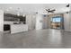 Open-concept living space with tile flooring, ceiling fan, and modern kitchen with stainless appliances at 2293 Teatro Ave, Henderson, NV 89044