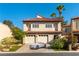 Charming two-story home with a two-car garage, terra cotta roof, and well-maintained landscaping at 2845 Queens Courtyard Dr, Las Vegas, NV 89109