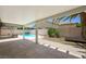 Spacious covered patio offering views of the pool and landscaped backyard with mature palms at 315 Barletta Ave, Las Vegas, NV 89123