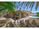 Attractive backyard features a covered patio, lush landscaping, and a refreshing pool, ideal for leisure at 315 Barletta Ave, Las Vegas, NV 89123