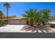 Inviting single-story home with a three-car garage and desert landscaping, including a mature palm tree at 315 Barletta Ave, Las Vegas, NV 89123